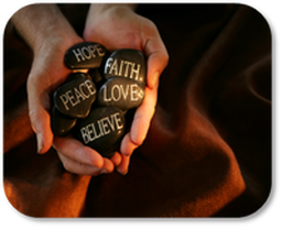Hands holding rocks with words of hope and inspiration engraved