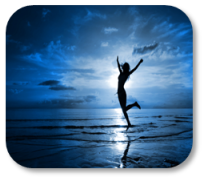 Image of a female dancing on the beach at sunset