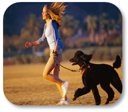 Photograph of a girl running with her dog